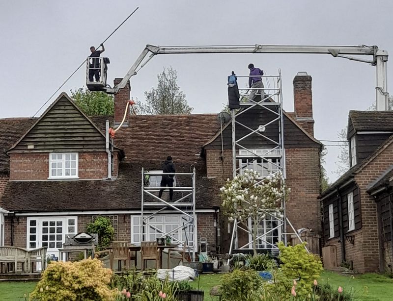 The Roof Moss Cleaners using cherry picker and scaffolding to clean roof safely and professionally in Chinnor, Oxfordshire